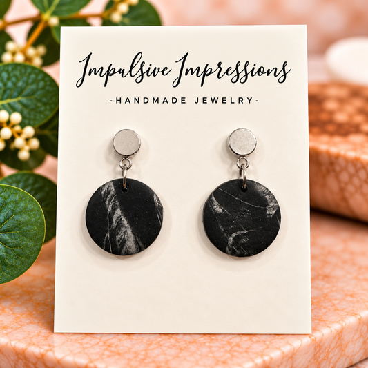 Black and gray marbled round polymer clay earrings with silver-tone circular studs