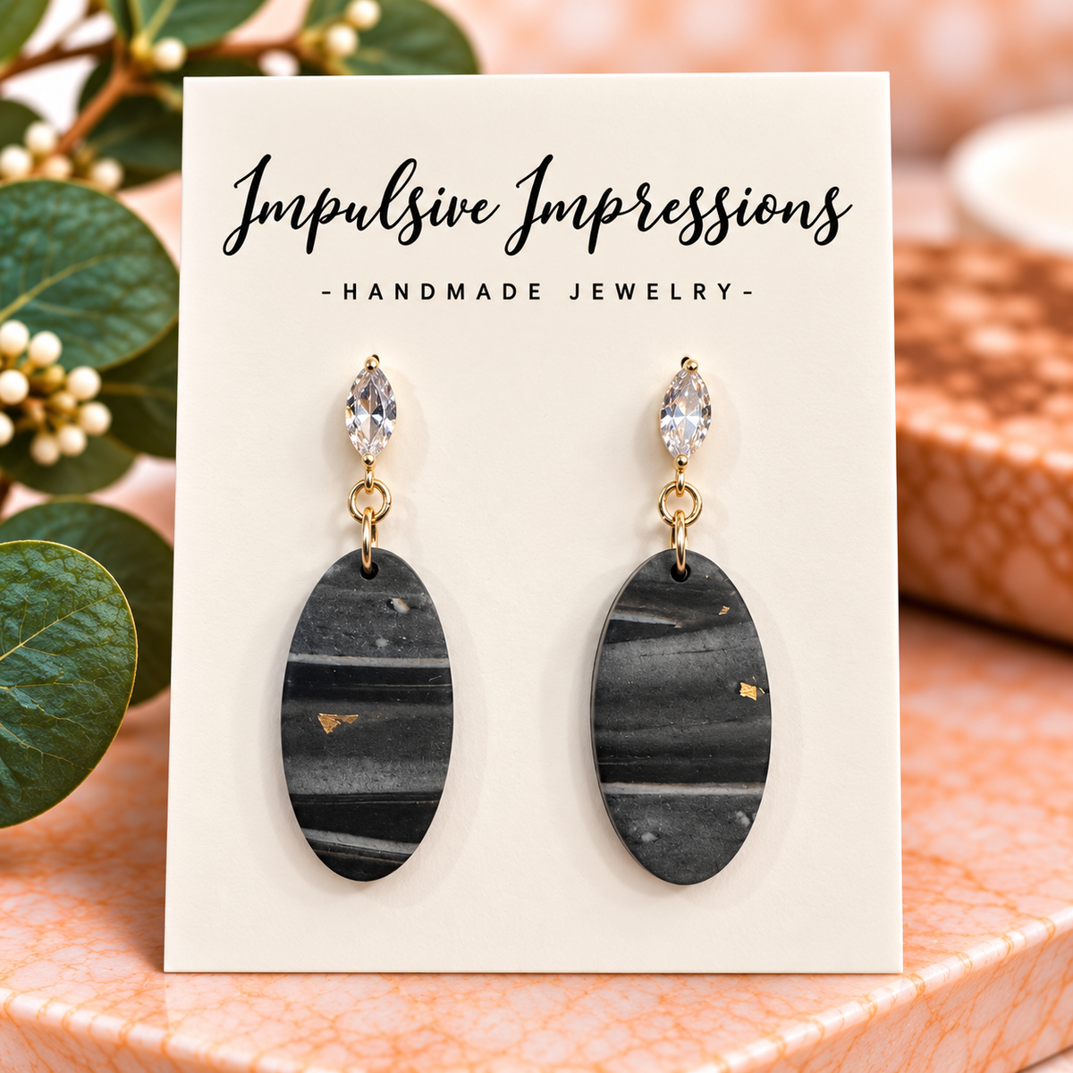 Charcoal gray striped oval polymer clay earrings with clear marquise crystal studs and gold-tone links