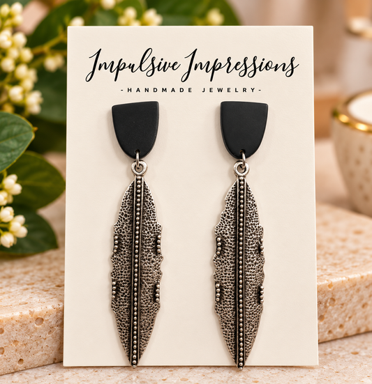Matte black and antique silver feather drop earrings
