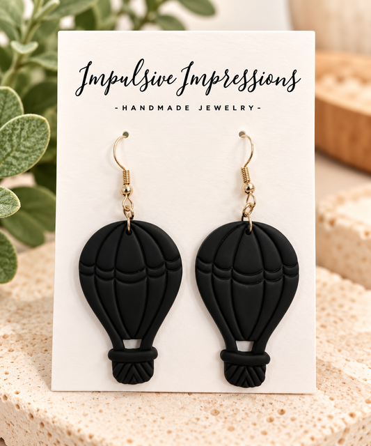 Matte black hot air balloon earrings with gold hooks