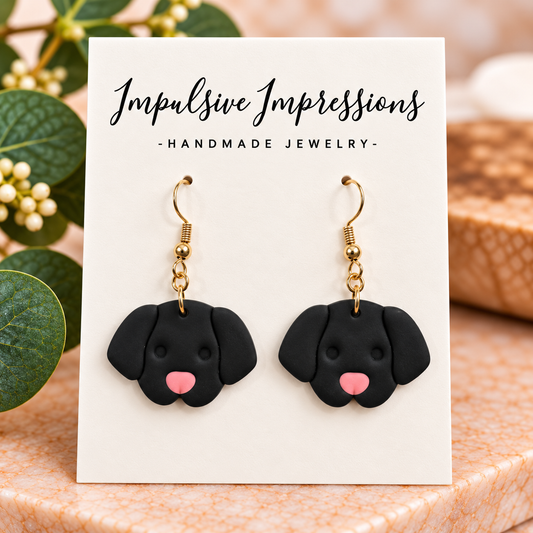 Black puppy polymer clay earrings with pink noses and gold-tone hooks
