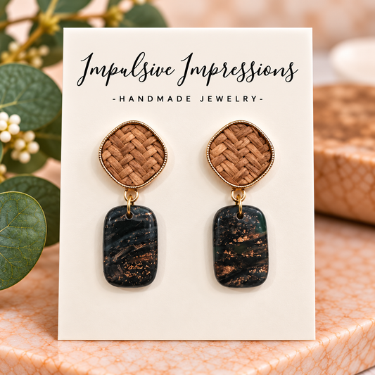 Black and gold polymer clay drop earrings with woven tan studs