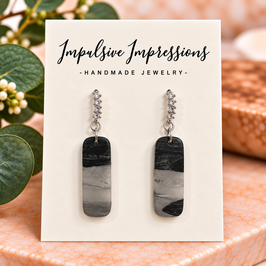 Black and gray marbled polymer clay rectangular earrings with silver crystal accents
