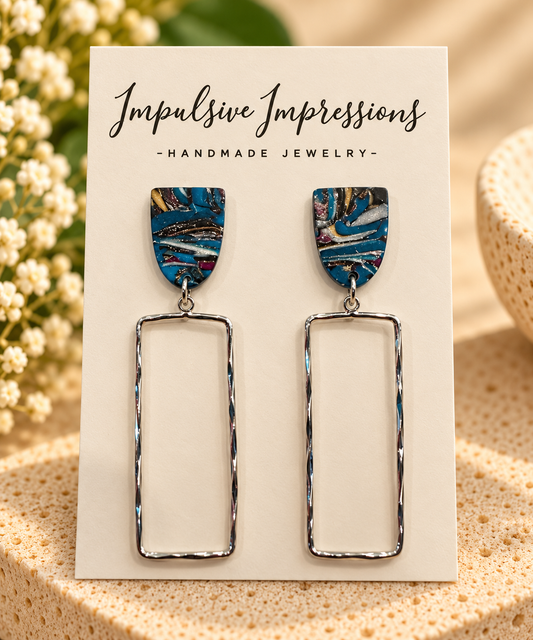 Handmade blue marbled polymer clay stud earrings with long open silver-tone rectangle drops