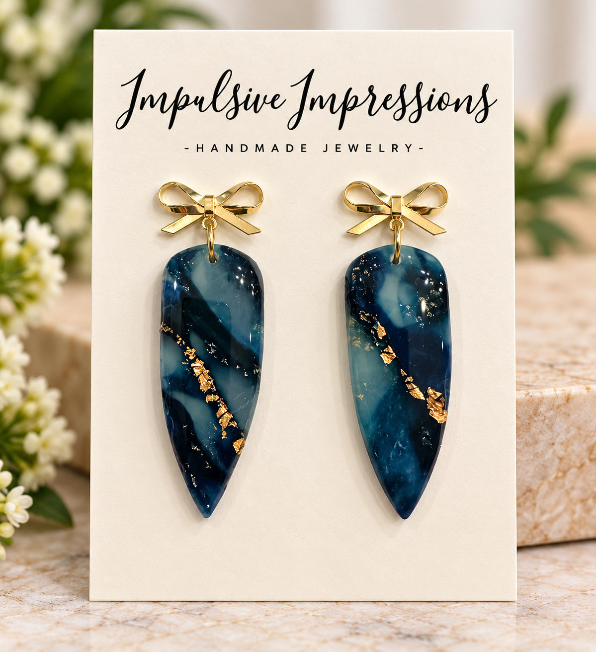 Teal marbled polymer clay earrings with gold bow studs